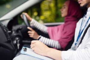 driving school concept male instructor examining theory test